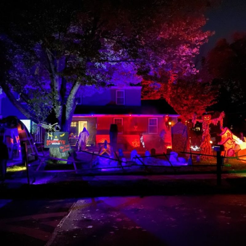 Halloween night (2021) This year we did a graveyard theme with a crypt, many tombstones and a large scarecrow. I used LED spotlights that allowed me to pick colors to get the effect I wanted. I mounted them to the gutters, behind bushes, and around the graveyard. I also used smoke machines and speakers to play custom made spooky soundtracks. I was very inspired by Universal Studios' Halloween Horror Nights. There is also a giant spider web lit with blacklight and window projections. See the 2021 Walkthrough